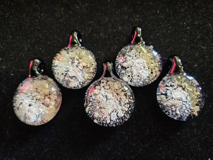 Wearable glass pendants designed to hold a small amount of a loved one’s ashes