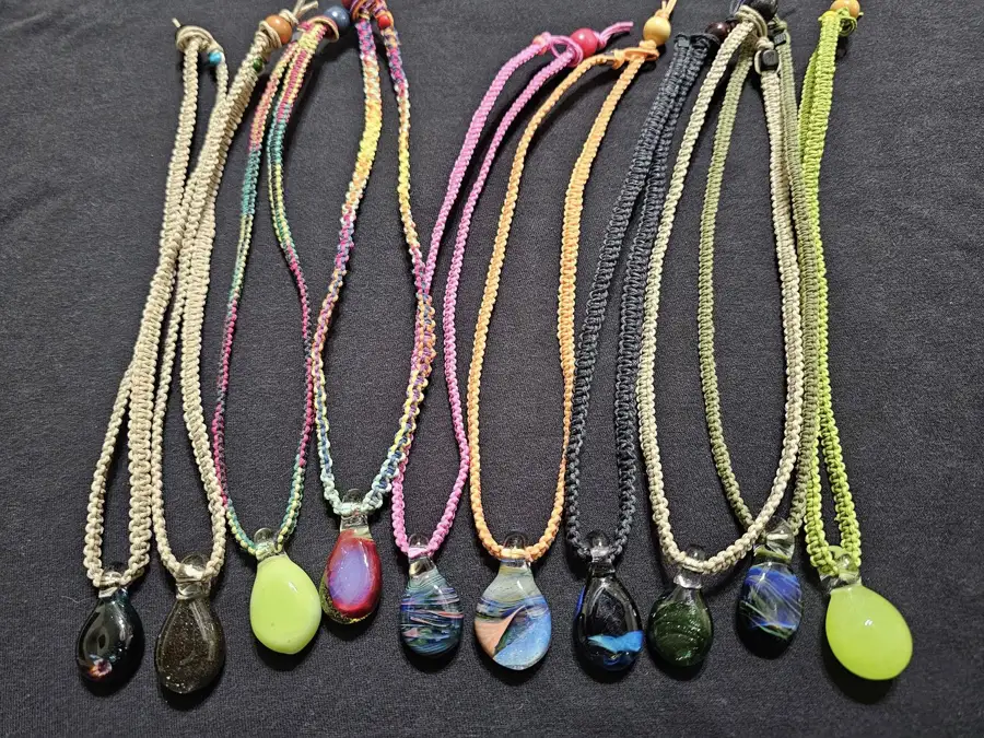 Colorful glass pendants on woven cords